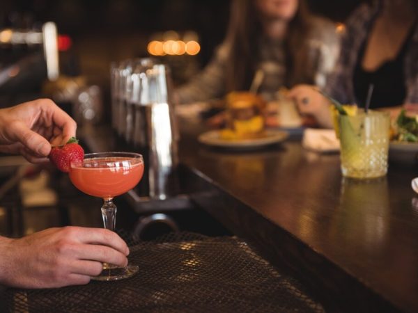 bartender-holding-cocktail-bar-counter-1024x683
